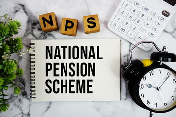 NPS National Pension Scheme text with calculator and alarm clock on marble background