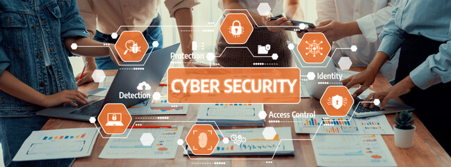 A diverse team discusses cyber security strategies in a modern office, collaborating over digital devices and diagrams with a focus on protection and access control. Amity