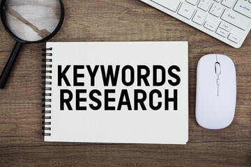 Keywords Research text written on notepad with keyboard, optical mouse and magnifying glass on...