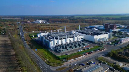 Modern big data center facility standing in an industrial area, serving digital information and connectivity. Fantastic aerial view flight ascending raise up panorama orbit drone