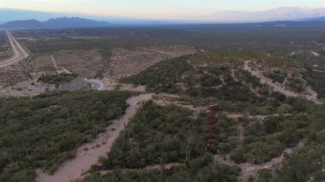 Aerial shot of Cable Carril mining structures winding through the landscape and vegetation near Chilecito, La Rioja, Argentina.