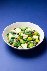 Salad with spinach, blue cheese, pear, grapes, and nuts. Healthy eating. Vegetarian.