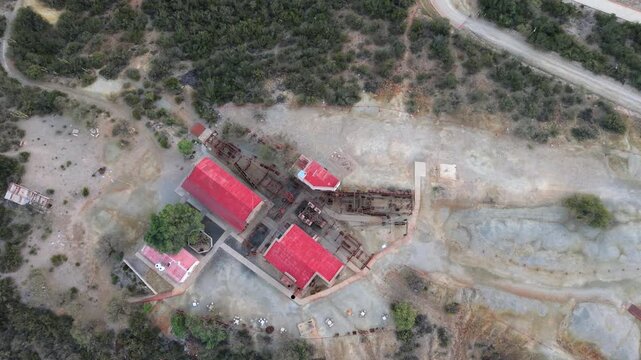 Cenital drone view of Estaci&oacute;n 2 Cable Carril&rsquo;s red-roofed buildings and mining ruins in Chilecito, La Rioja, Argentina.