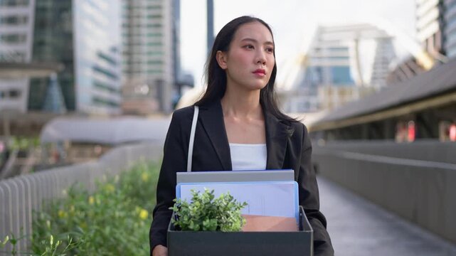 Asian businesswoman feeling sad and discouraged after losing her job.