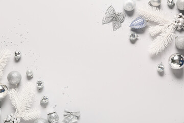 Frame made of Christmas balls, confetti and fir tree branches on white background