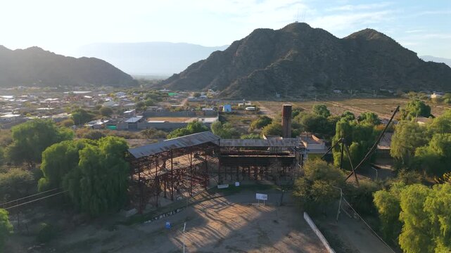 Historic mining machinery and metal structures of Estaci&oacute;n 1 Cable Carril with mountain backdrop, Chilecito, La Rioja, Argentina.
