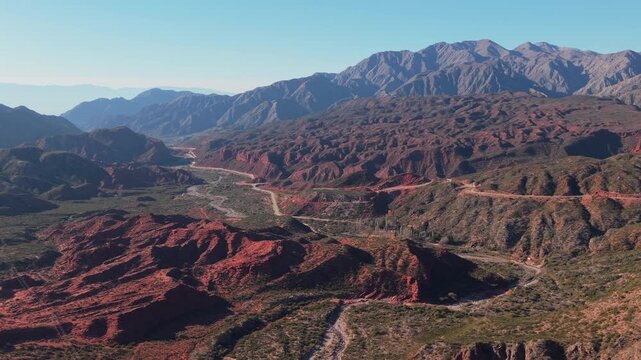 Cuesta de Miranda's layered red rock formations and distant peaky mountain ridge from above, Chilecito, La Rioja Province, Argentina