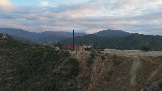 Cenital drone view of Estaci&oacute;n 2 Cable Carril&rsquo;s red-roofed buildings and mining ruins in Chilecito, La Rioja, Argentina.