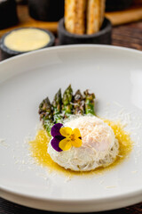 Poached egg served with asparagus and buttery golden sauce