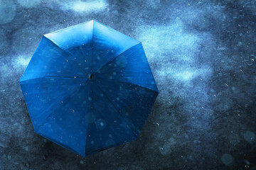 Top view blue umbrella on the street with asphalt road background