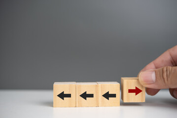 New ways of working, differentiation strategy concept symbol on wood blocks. Providing uniqueness, different and distinct from competitors, creating competitive advantage. Business direction concept.