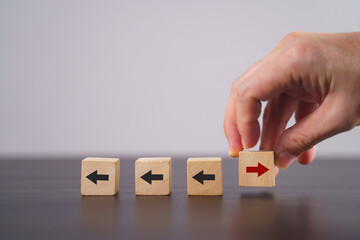 New ways of working, differentiation strategy concept symbol on wood blocks. Providing uniqueness, different and distinct from competitors, creating competitive advantage. Business direction concept.