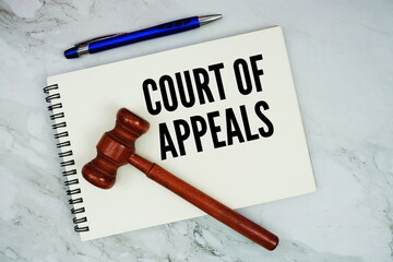 Court Of Appeals text written on notepad with pen and judge gavel on marble background