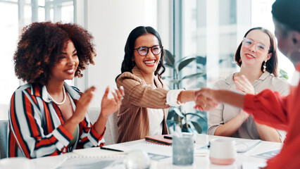 Business women, meeting or applause with handshake for deal, agreement or promotion in office. Female people, employees or colleagues shaking hands with smile or team for congratulations or thank you