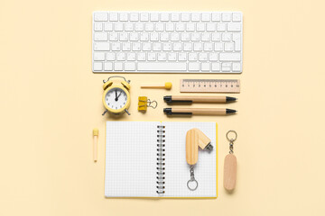 Composition with notebook, stationery and modern flash drives on beige background