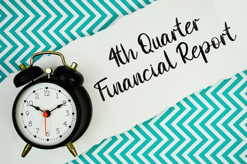 4th Quarter Financial Report text written on paper rip with alarm clock flat lay on turquoise chevron background