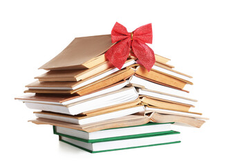 Christmas tree made of different books and bow on white background