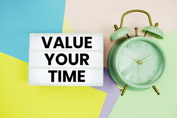Value Your Time text in lightbox with alarm clock on pastel background