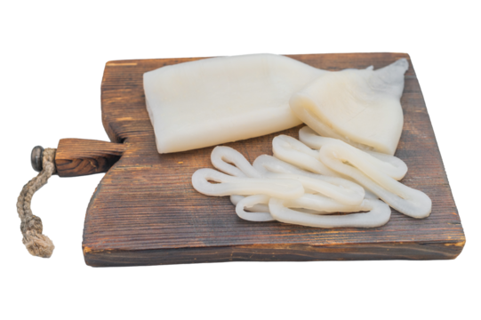 Fresh squid tubes and rings on a rustic wooden board with herbs create a clean seafood composition ideal for culinary and market themes