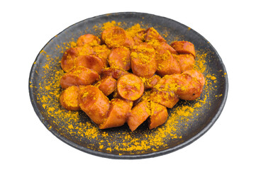Traditional currywurst sprinkled with curry powder on black dish great for German street food concepts and high quality food photos.