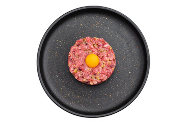 Beef tartare with egg yolk on a black plate over bright background perfect for gourmet recipes restaurant menus and premium food stock images.