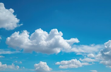 Obraz premium Fluffy white clouds drift across a brilliant blue sky