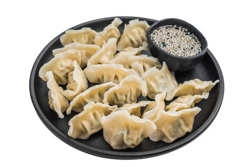 Steamed jiaozi dumplings and sesame in a black plate on a light background Asian gyoza mandu potstickers traditional cuisine closeup