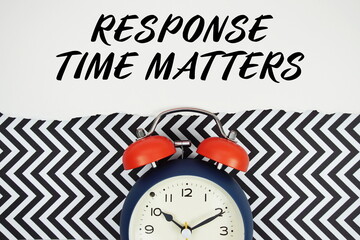 Response Time Matters text written on paper with alarm clock on black chevron background