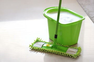Mop with bucket of water in living room