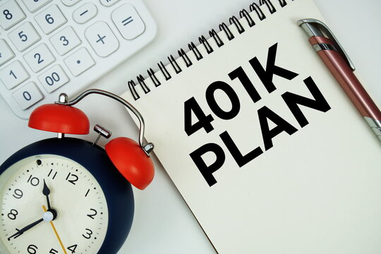 401 Plan text written on notepad with alarm clock and calculator on white background - Powered by Adobe
