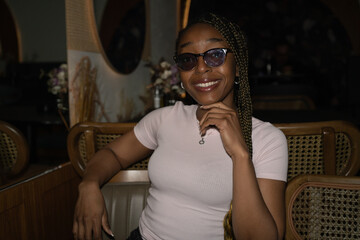Portrait of a young black woman smiling in a restaurant