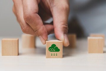 Carbon emission concept. Sustainable business development. Net zero emissions. Renewable energy, sustainable technology, ecology solutions. Wood block with CO2 emission reduction icon.