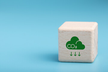 Carbon emission concept. Sustainable business development. Net zero emissions. Renewable energy, sustainable technology, ecology solutions. Wood block with CO2 emission reduction icon.