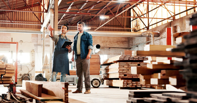 Carpentry, planning and people on tablet in workshop for meeting, construction or woodworking business. Carpenter, teamwork and men on digital tech for online inventory for timber, lumber and talking - Powered by Adobe