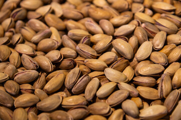 close-up of organic salted pistachios. A high-protein, nutritious snack with a crunchy filling. Shows the natural shell and the nut inside.