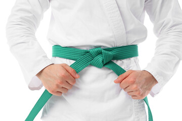 Young man with green belt practicing karate on white background, closeup © Pixel-Shot