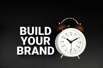 Build Your Brand text with alarm clock on black background