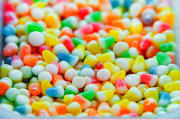 Colorful background of multicolored, shiny, round, chewy candies. A background photo of colorful sweets. A close-up photo of the candies taken in a candy store