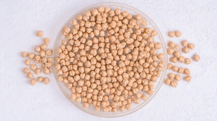 Fototapeta premium Raw chickpeas in a glass bowl on white background isolated. Generative AI