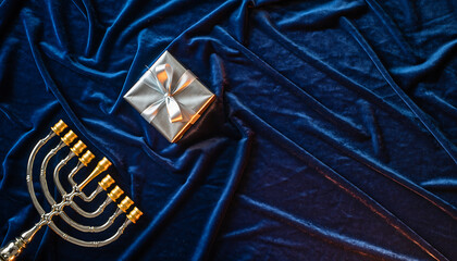 Elegant silver Hanukkah gift and menorah shine on rich velvet texture, evoking holiday warmth, tradition, and joyful celebrations for festive designs