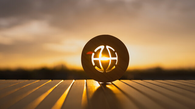Wooden globe icon with sunrise light behind, symbolizing global currencies, international financial systems, global economy, digital money, forex market, and worldwide monetary connection.