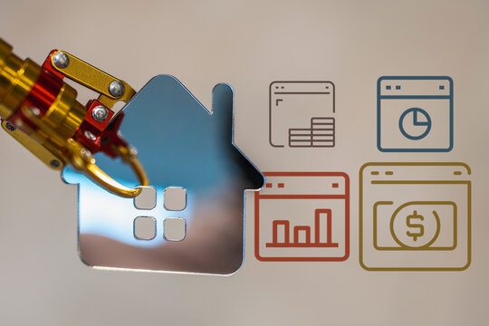 Robotic arm holding a metallic house icon represents smart home automation, digital real estate investment, and future property technology with data analytics and AI integration.