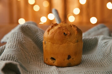 Closeup of Christmas bread with dishtowel and Christmas lights in background