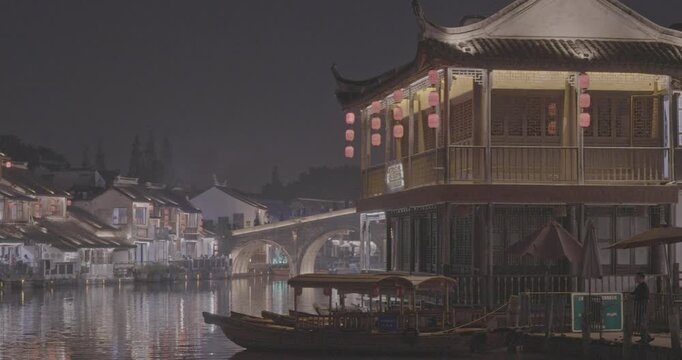Idyllic night scene with lantern-adorned buildings by the riverbank. Zhujiajiao, Shanghai, China