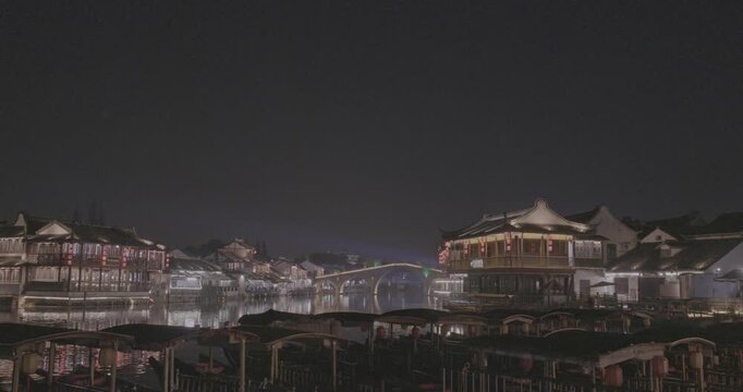 Illuminated Bridge Over Water at Night in Scenic Traditional Town. Zhujiajiao, Shanghai, China