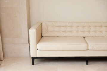Modern minimalist beige sofa design. A stylish beige sofa with tufted details sits elegantly in a minimalist setting. perfect for contemporary living spaces, combining comfort with aesthetic appeal