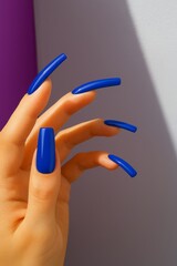 stylish model presents meticulous manicure with luminous polish and sophisticated background setting
