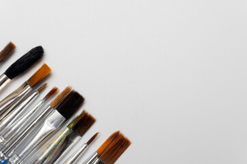 photograph of brushes on a white background. There's space for an artist's sketch. Art and its tools