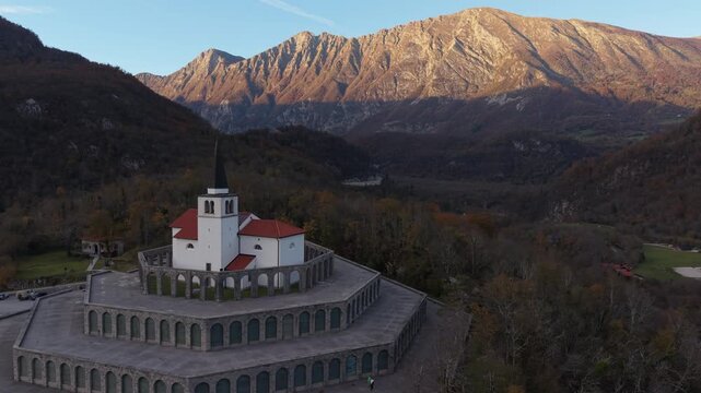 Aerial rotating view of the St Anton Church and Kobarid Ossuary, a World War I memorial in Slovenia