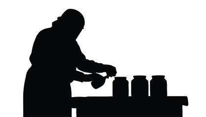 Person in silhouette carefully preserving food in glass jars on a table